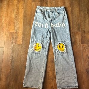 Denim jeans with emoji face and says rock baby
